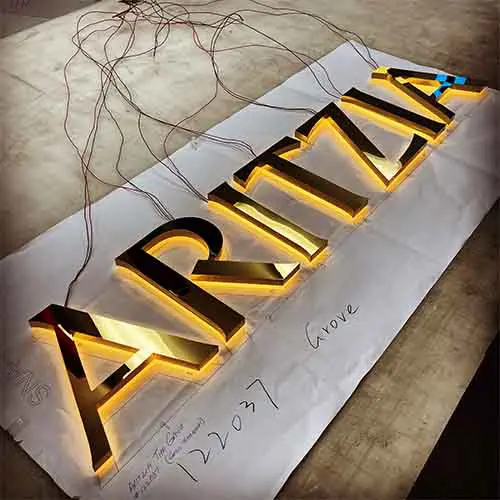 Aritzia logo gold illumunated