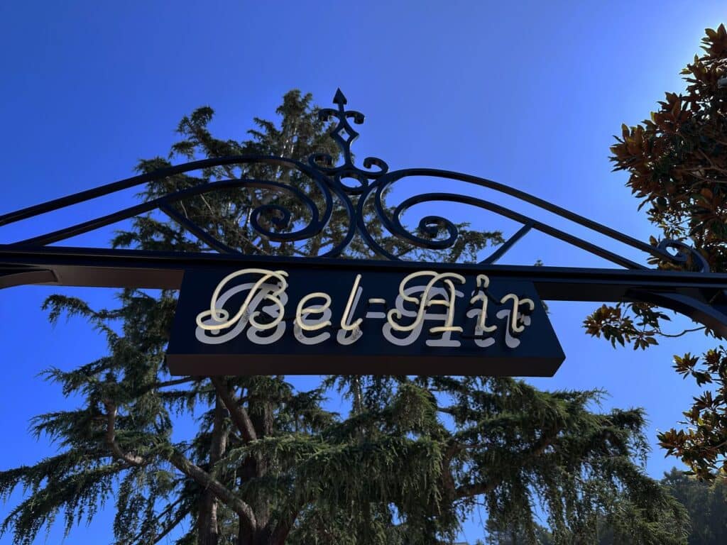 ornamental wrought iron arch with &ldquo;Bel-Air&rdquo; script panel sign in Bel-Air, Los Angeles, CA