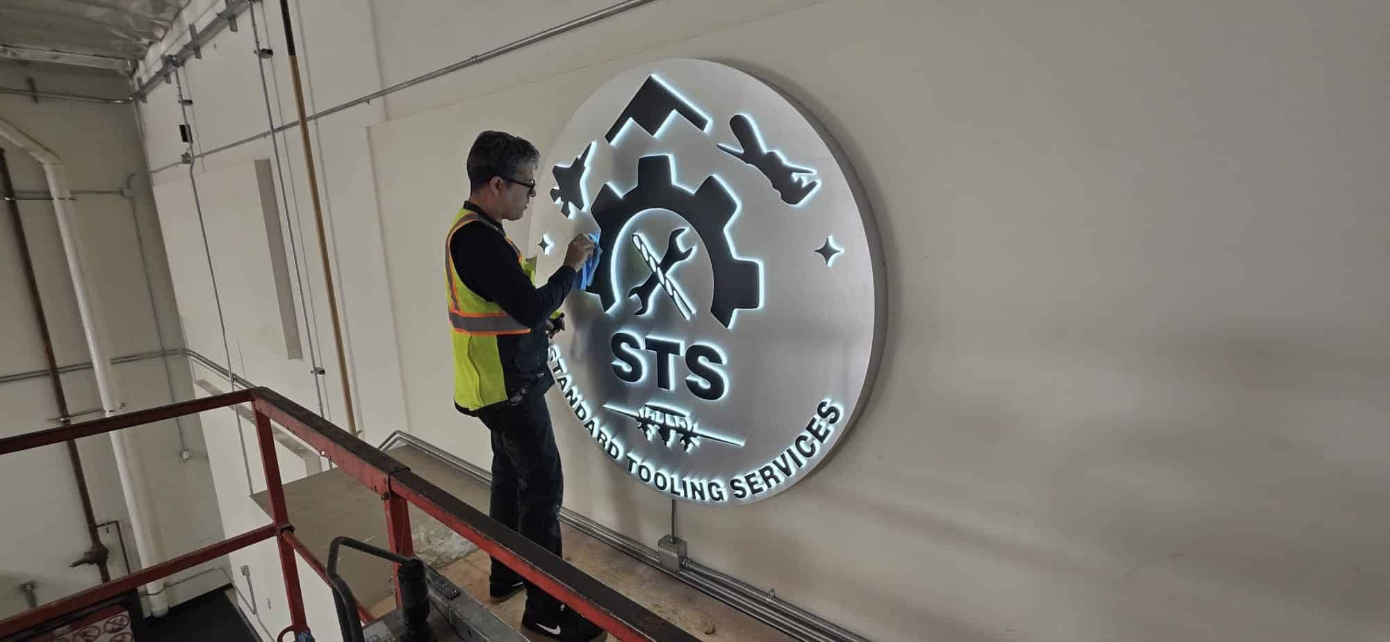 Aritzia halo-lit stainless steel channel letters staged and tested in shop prior to installation at The Grove