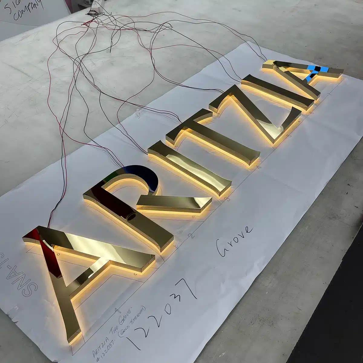 Business Sign Light Repair in Los Angeles, CA 2 Halo-lit gold channel letters with LED wiring exposed