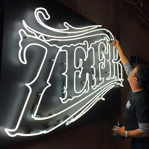 Business Sign Light Repair in Los Angeles, CA 3 Technician servicing a white neon business sign
