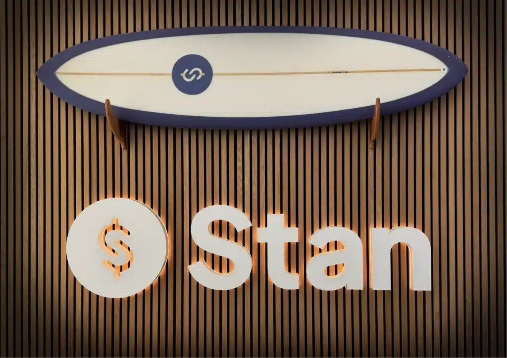 Dimensional lobby logo sign and branded surfboard on a wood-slat wall in Studio City, CA